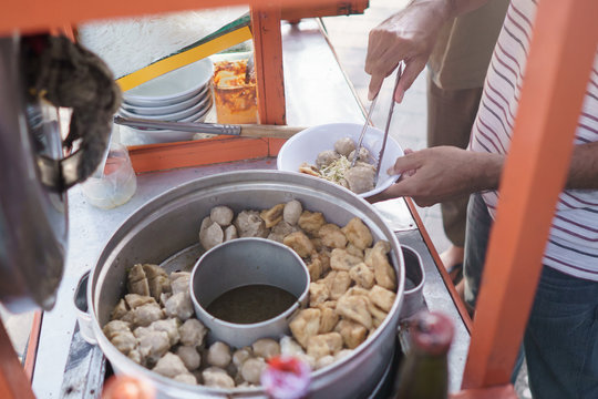 bakso meatball seller preparing the dish for customer