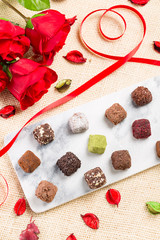Variety chocolate truffles and rose