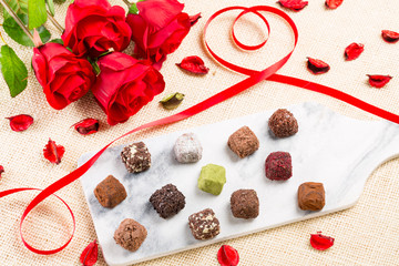 Variety chocolate truffles and rose