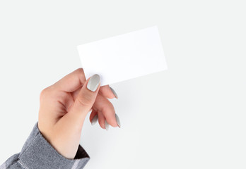 Fototapeta premium Beautiful womans hand with manicure holding business card