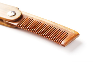 Sandalwood comb on a white background. Hair care.