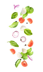 Mozzarella cheese, tomatoes, onion and basil leaves falling on white background