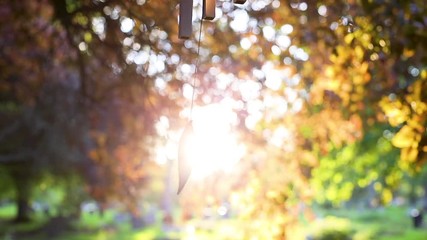 Stunning sunset backlighting slow motion wind chime in temple garden - Powered by Adobe