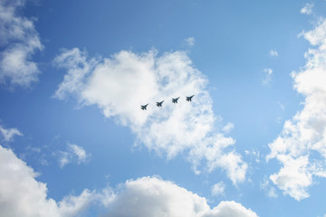 Fototapeta premium A group of warplanes flying at the blue sky