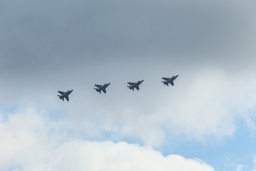 Naklejka na ściany i meble A group of warplanes flying at the blue sky