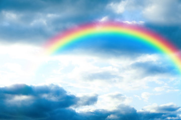 Picturesque view of beautiful rainbow and blue sky on sunny day