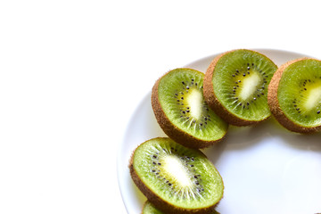 Kiwi fruit sliced on a snow white plate