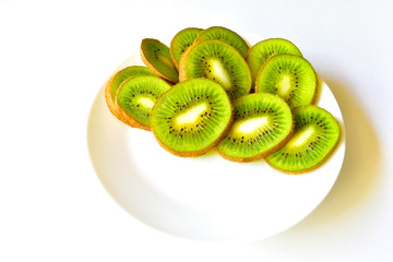 Kiwi fruit sliced on a snow white plate