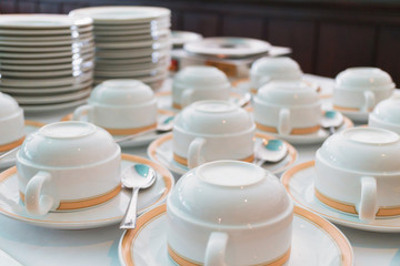 Group of ceramic cup and plates stacked on the table for tea or coffee service