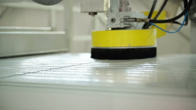 Production of sandwich panels. The cutting section with a circular saw and a deburring system.