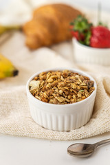 Oatmeal in a white bowl  on a light background