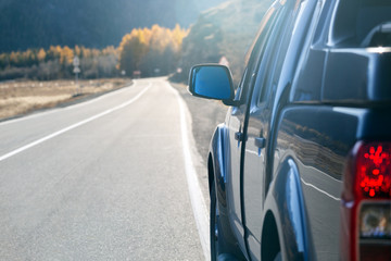 Fototapeta premium Tourism car on highway with sunset landscape in mountain. Auto Travel concept.