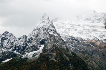 Snowy mountains with severe rocky peaks in Dombay, Caucasus, Karachay-Cherkessia, Russia.