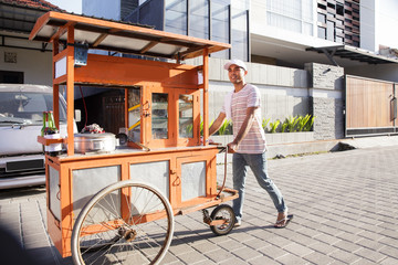 man selling bakso in the carts. indonesia street food. small business entrepreneur