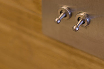 Electric switches on the wooden wall.