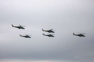 Fototapeta na wymiar Combat helicopters fly to the May 9 parade