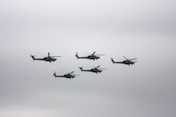 Fototapeta na wymiar Combat helicopters fly to the May 9 parade