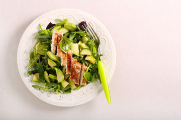 Green salad with chicken fillet on top, served