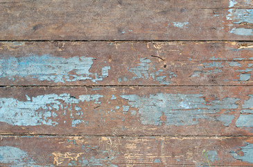 Old painted boards wall closeup background as texture of blue peeling paint on a wooden surface vertical lines on grunge wood fence.