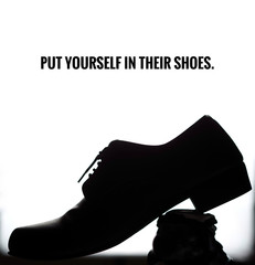 black silhouette shadow shoe of salary man on white background with idiom put yourself in their...