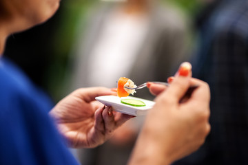 woman prepare to taste small food on spoon