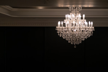 crystal chandelier shines hanging from the ceiling in the room