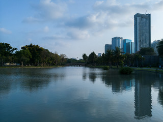 Blue Day - Clam pond landscape in the park near urban city