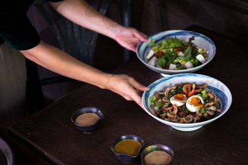 waitress serving healthy japanese salad