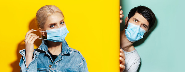 Collage of young guy and girl wearing medical face mask against coronavirus on two backgrounds of yellow and aqua menthe colors.