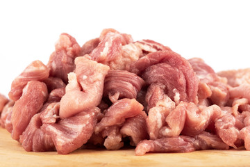 Close up. Chopped pork on a cutting board over a white background.