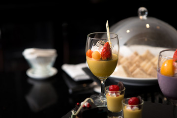 mango smoothie topped with several fruit