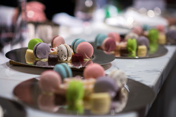 colorful macaroon on reflextion slate platter