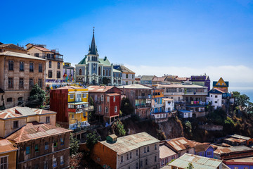 Valparaiso, Chile - March 08, 2020: Far View to the Cathedral and Colored Buildings with Bright Painting on the Street