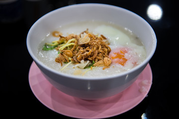 egg congee on dark background