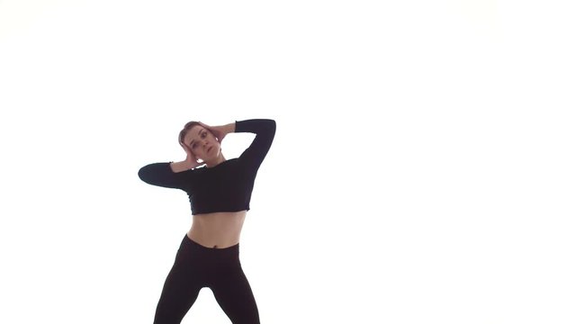 young beautiful woman dancer in black short top and black leggings dancing contemporary, modern ballet dance, isolated, medium long shot