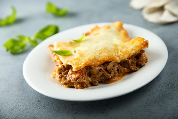 Traditional homemade lasagna with fresh basil
