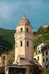 Fototapeta na wymiar Bell tower of the Cinque Terre overlooking the sea. It has a watch that characterizes it.