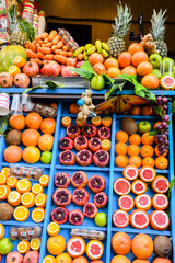 Juice bar background concept. Fresh exotic fruits wall Juicing Fresh Pomegranates Market Stall