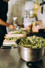 Professional chef working in restaurant kitchen and making delicious traditional food.