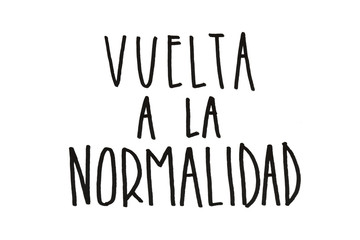 hand written quote in spanish that says vuelta a la normalidad (back to normal) concept for new normal after self-isolation and quarantine period of Covid-19. New normal in spanish