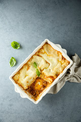 Traditional homemade lasagna with fresh basil
