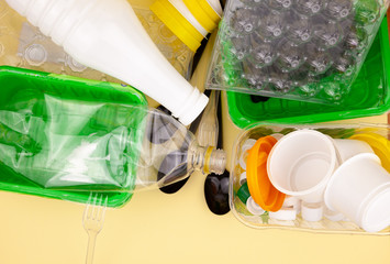 Sorting garbage. Plastic waste for recycling. Plastic bottles, containers, forks, spoons, egg...