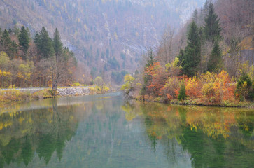 Beautiful lake with mirror reflection of autumn scenery at Slovenia.