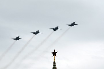 A group of tactical front-line bombers with a variable sweep wing Su-24M (Fencer) flies over Red...