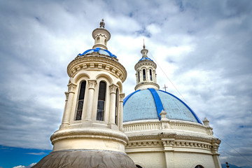 Domes and towers of the beautiful and old Cathedral of Cuenca, Ecuador, South America, on a sunny morning.