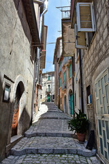 A narrow street between old buildings in the medieval town of Cusano Mutri, in the province of Avellino
