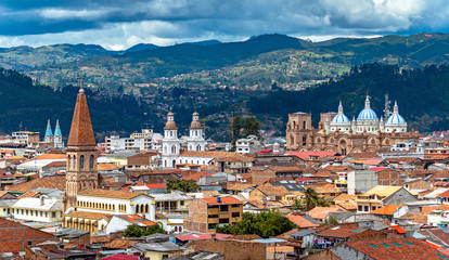 View of the city of Cuenca, with it's many churches, cathedrals and houses, in the middle of the Ecuadorian Andes, on a sunny afternoon, Ecuador, South America. - obrazy, fototapety, plakaty