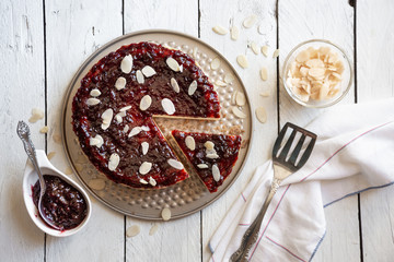 Homemade delicious cheesecake with fruit jam and almonds