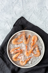 Fresh raw prawns prepared for cooking with pepper, lemon and parsley