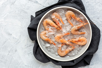 Fresh raw prawns prepared for cooking with pepper, lemon and parsley